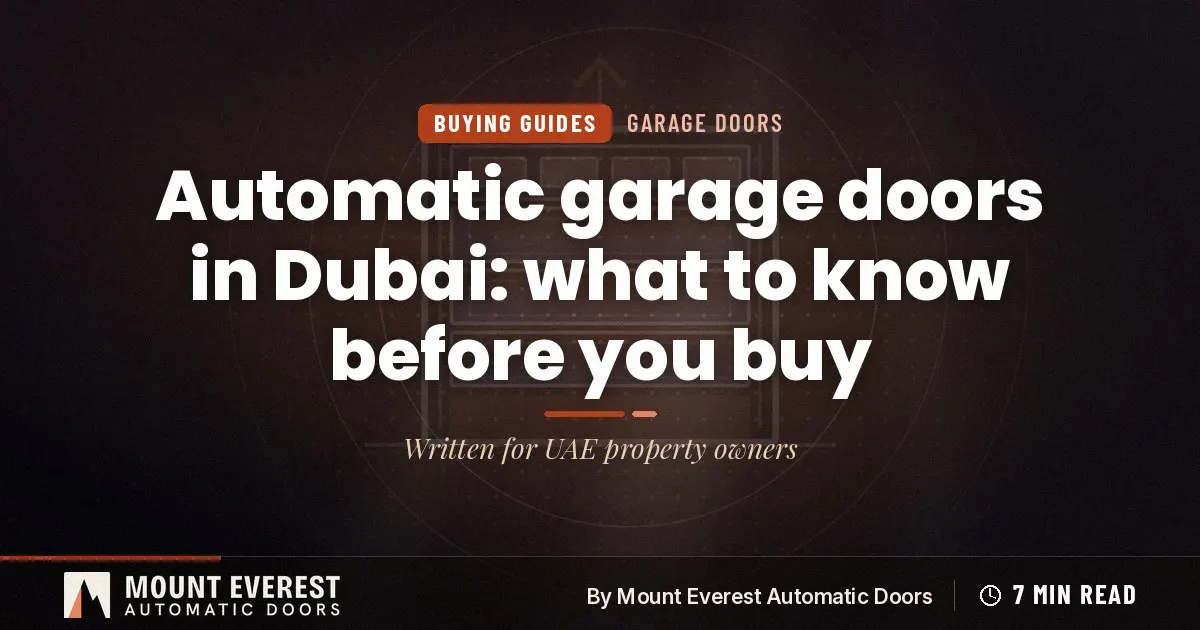 Technician checking the balance springs and opener rail of a sectional garage door in a Dubai villa garage