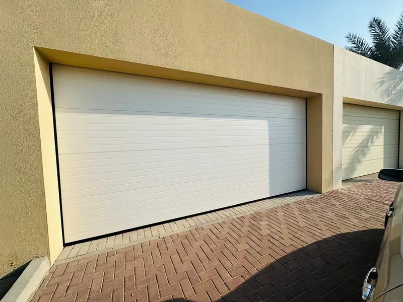 White sectional garage door in a recessed opening on a villa in Al Barsha South, Dubai